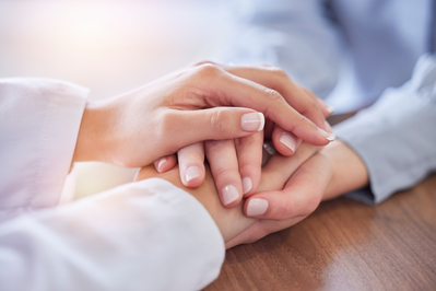 pharmacist holding patient's hands