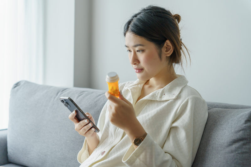 woman holding pill bottle